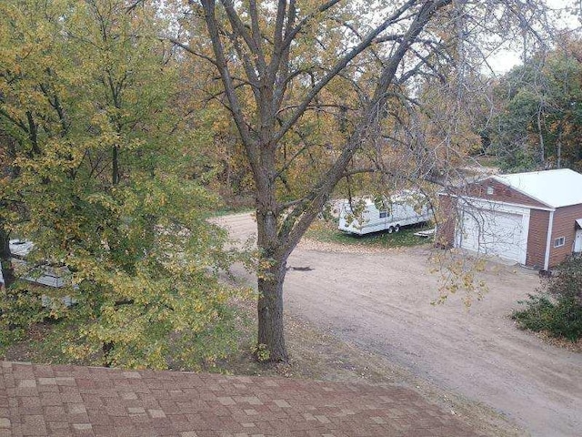 view of yard featuring an outbuilding and a garage