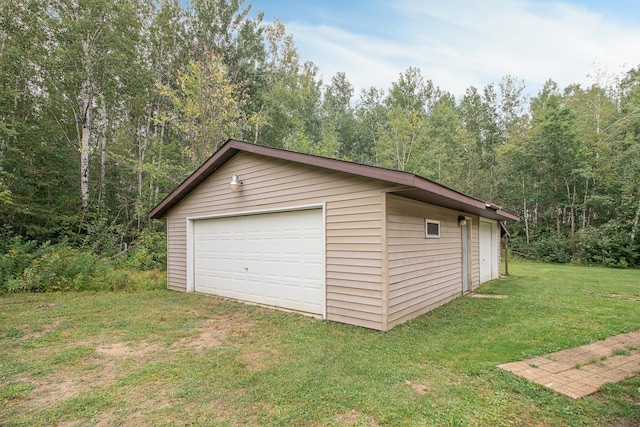 detached garage with a wooded view