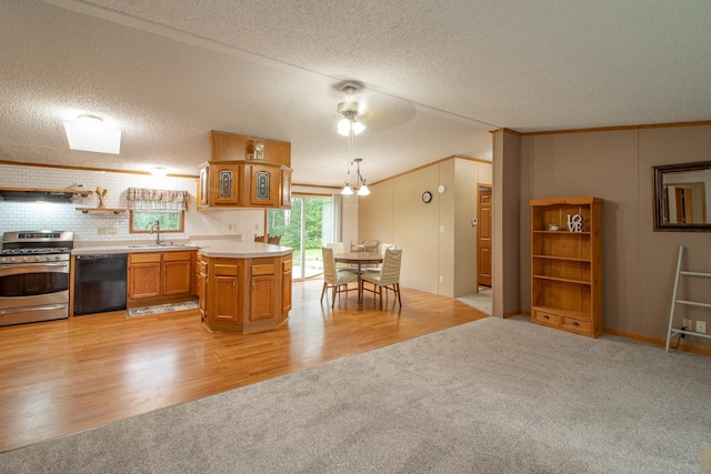 kitchen with dishwasher, stainless steel gas range, a sink, and light colored carpet