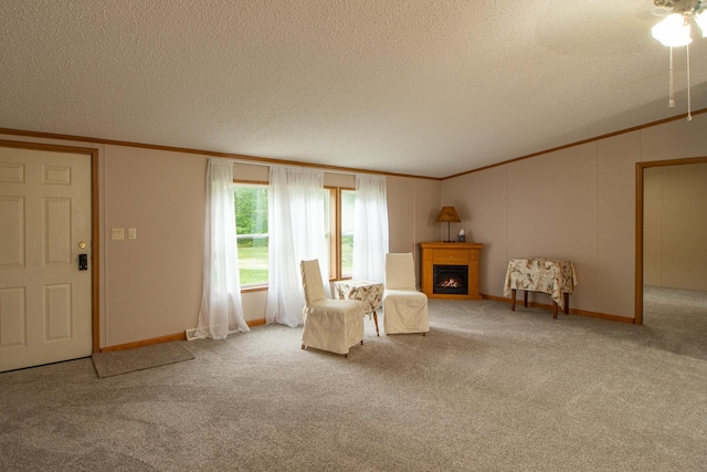 unfurnished room with a lit fireplace, ornamental molding, and carpet flooring