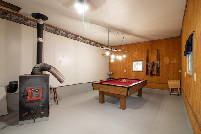 playroom featuring a wood stove, pool table, and wooden walls