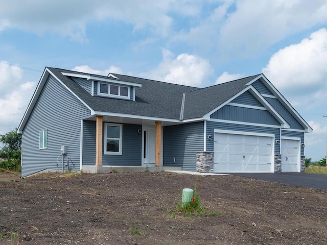 view of front of house featuring a porch and a garage