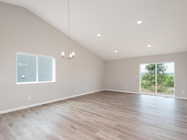 unfurnished room featuring a chandelier, recessed lighting, light wood-type flooring, and baseboards