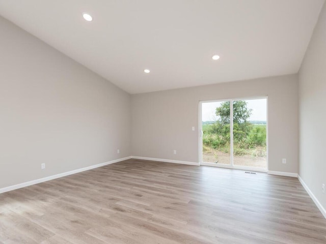 unfurnished room with recessed lighting, light wood-style flooring, and baseboards