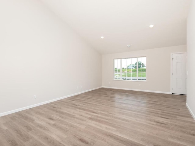 unfurnished room with baseboards, recessed lighting, and light wood-style floors