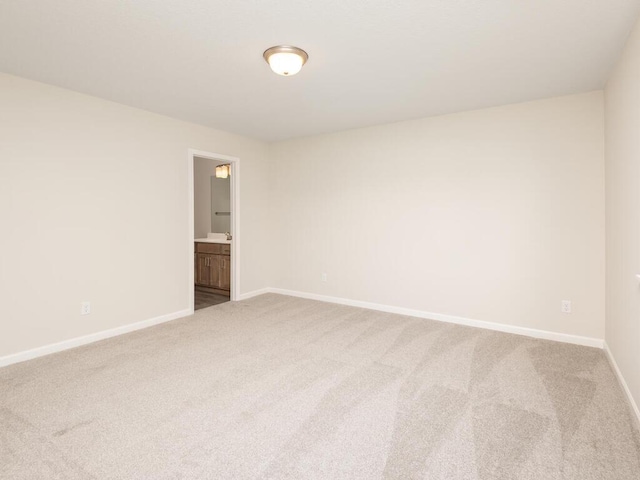 carpeted empty room with baseboards