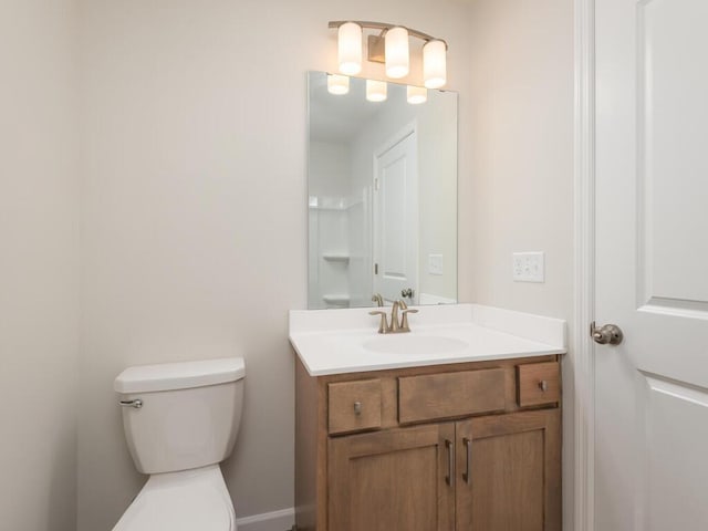 bathroom featuring toilet and vanity