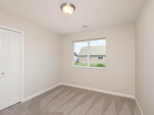 interior space featuring carpet and baseboards