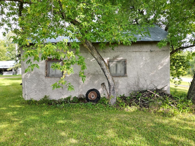 view of home's exterior featuring a lawn and stucco siding