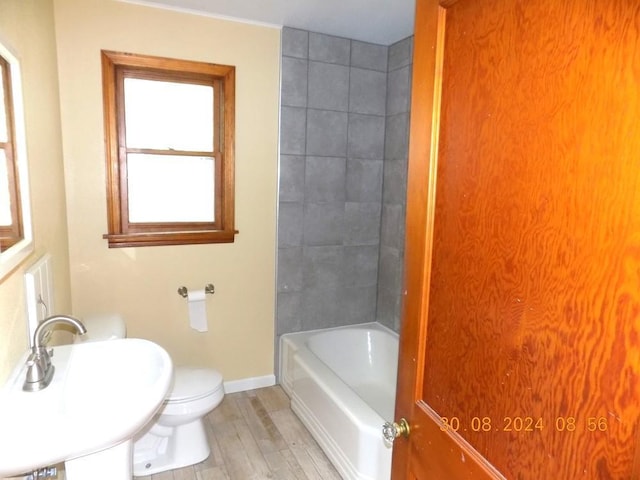 full bath with wood finished floors, toilet, baseboards, and a sink