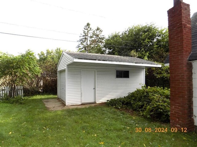 view of outdoor structure with a lawn