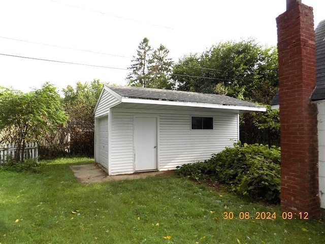 view of shed with fence