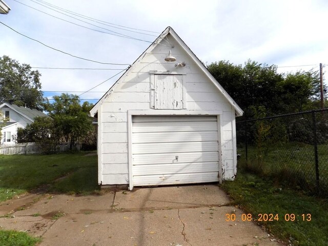 garage featuring a lawn