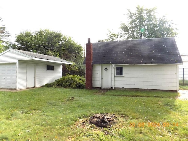 view of outdoor structure featuring a garage and a yard