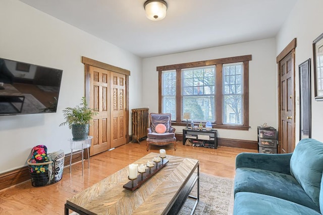 living room with radiator and light hardwood / wood-style floors