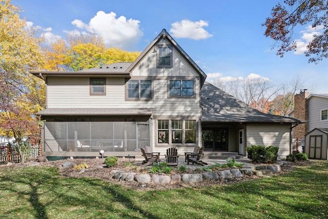 back of property with a yard, a sunroom, and a patio