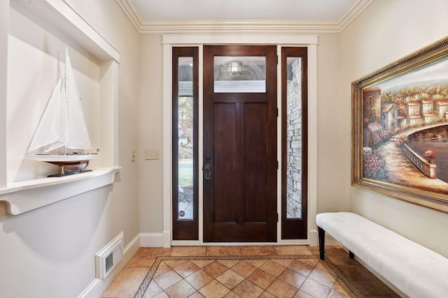 tiled entrance foyer featuring ornamental molding