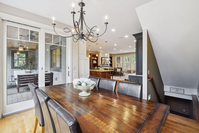 dining space featuring an inviting chandelier and hardwood / wood-style floors