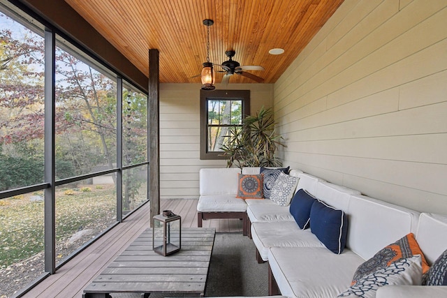 sunroom with lofted ceiling, wooden ceiling, and ceiling fan