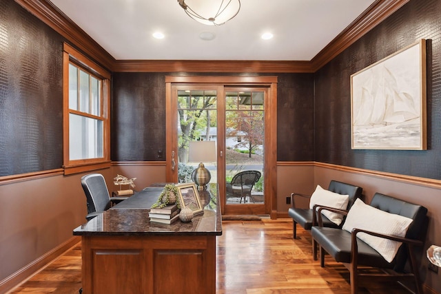 office area with light hardwood / wood-style floors and ornamental molding