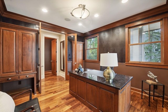 office space with ornamental molding and light hardwood / wood-style flooring