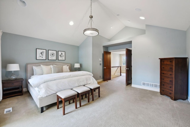 carpeted bedroom with high vaulted ceiling