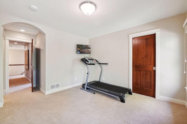 workout area featuring light carpet