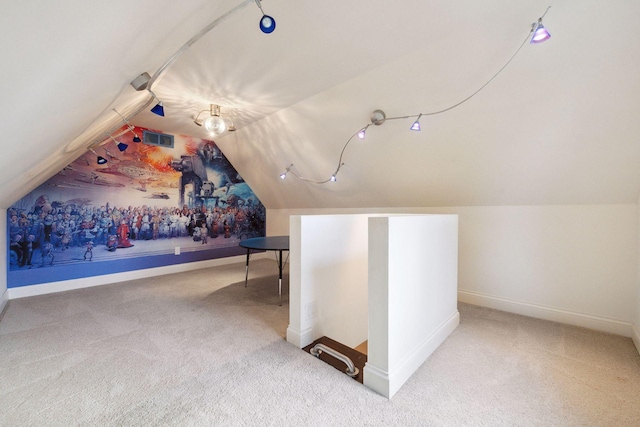 additional living space featuring carpet and lofted ceiling