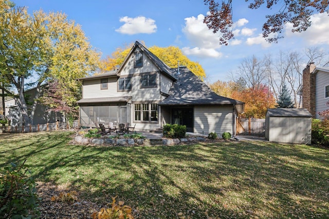 rear view of property featuring a patio area, a lawn, and a shed