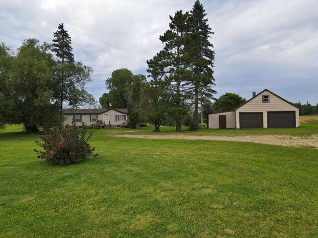 view of yard featuring an outbuilding and a garage