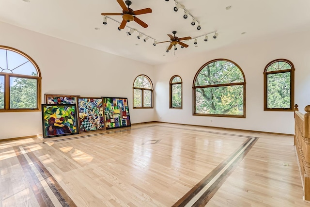 rec room featuring light hardwood / wood-style flooring and ceiling fan