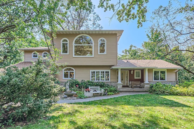 view of front of house with covered porch and a front yard