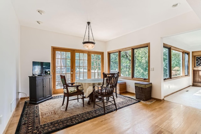 dining room with french doors and light wood-type flooring