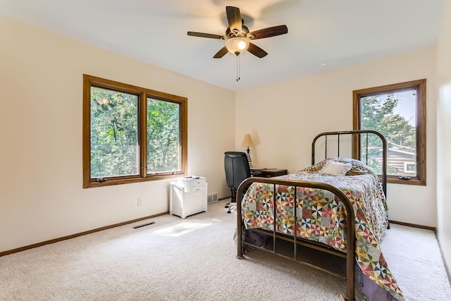 bedroom with carpet, multiple windows, and ceiling fan