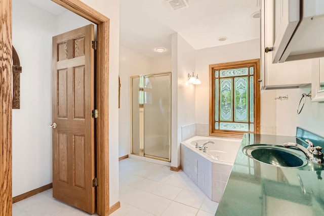 bathroom with plus walk in shower, vanity, and tile patterned flooring