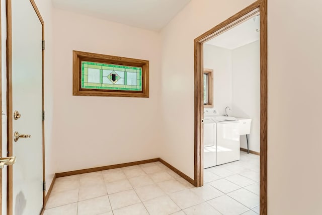 hallway featuring light tile patterned flooring and independent washer and dryer