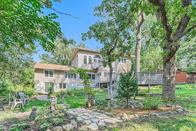 back of house featuring a wooden deck