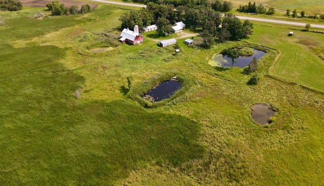 birds eye view of property with a water view and a rural view