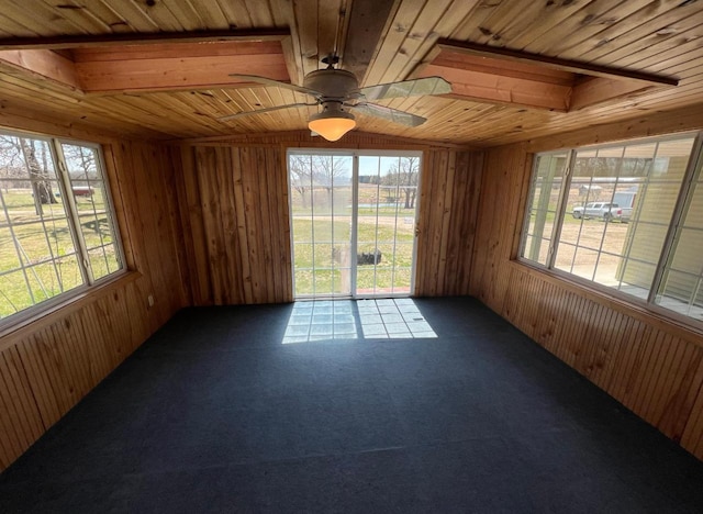 unfurnished sunroom with wooden ceiling and a ceiling fan