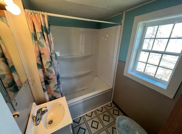 full bath with baseboards, shower / tub combo with curtain, and vanity