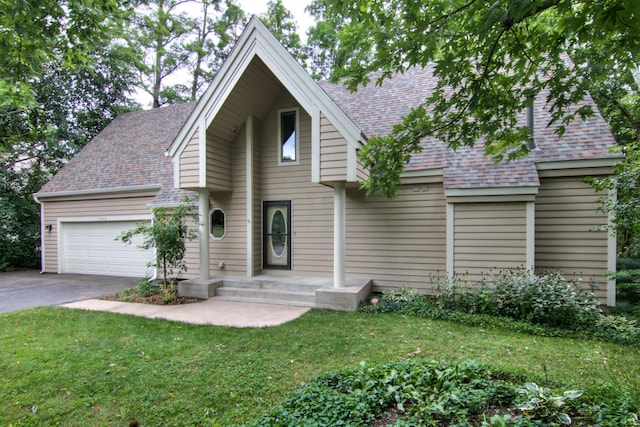 view of front of house featuring a garage and a front lawn