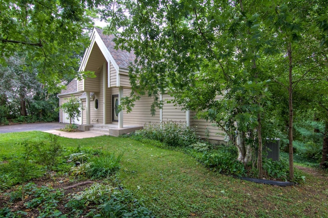 exterior space featuring a garage and a front lawn