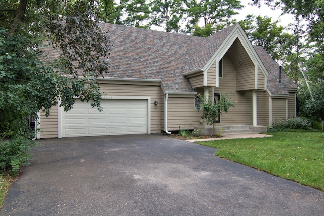 view of front of house with a garage and a front lawn