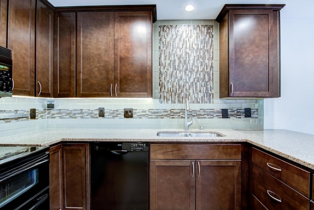 kitchen featuring sink, tasteful backsplash, dark brown cabinets, black appliances, and light stone countertops