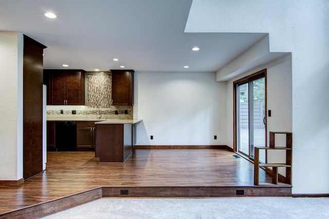 kitchen with dark brown cabinetry, sink, dishwasher, dark hardwood / wood-style flooring, and decorative backsplash