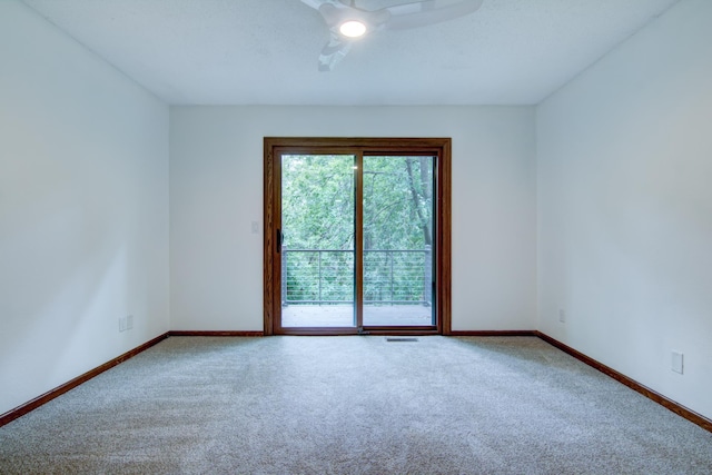 spare room with carpet flooring and ceiling fan