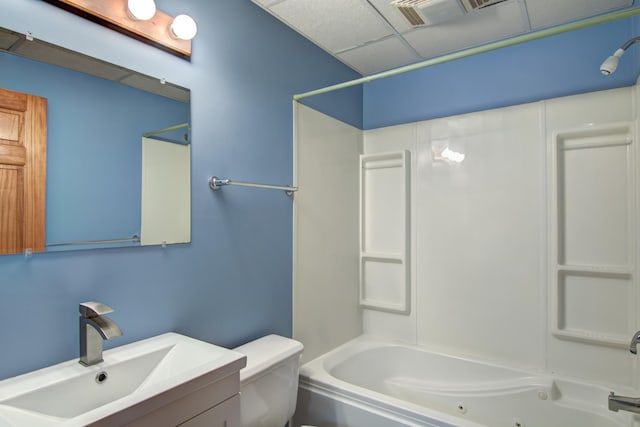 full bathroom featuring a drop ceiling, vanity, toilet, and shower / bath combination