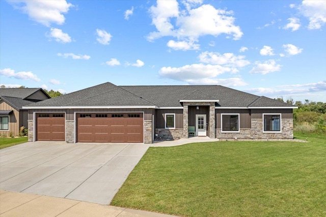 prairie-style house with a front lawn, driveway, a garage, and stone siding