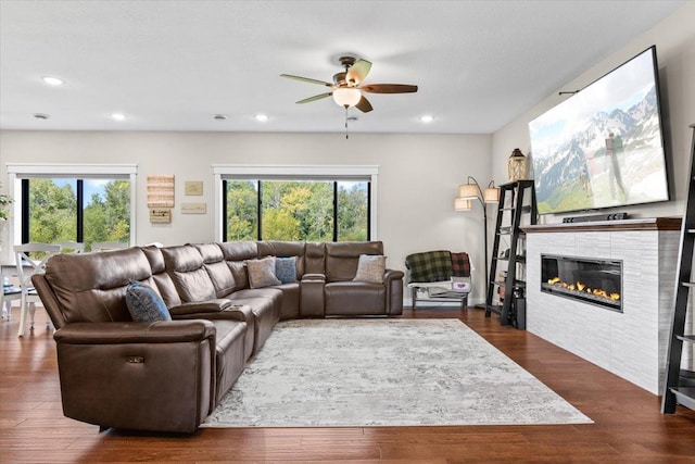 living area with a wealth of natural light, dark wood finished floors, and recessed lighting