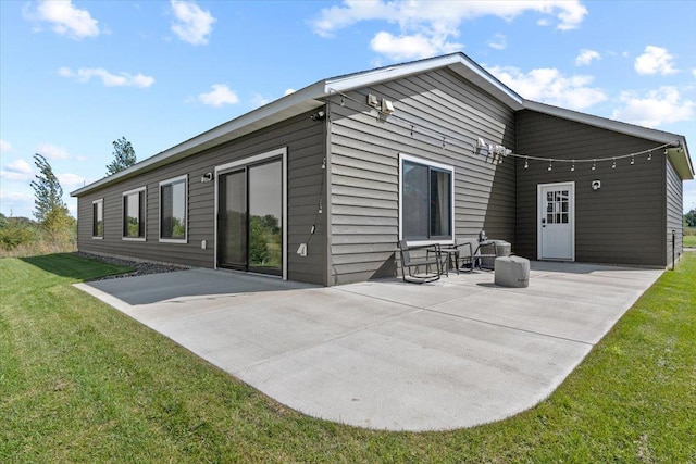 back of property featuring a yard and a patio area